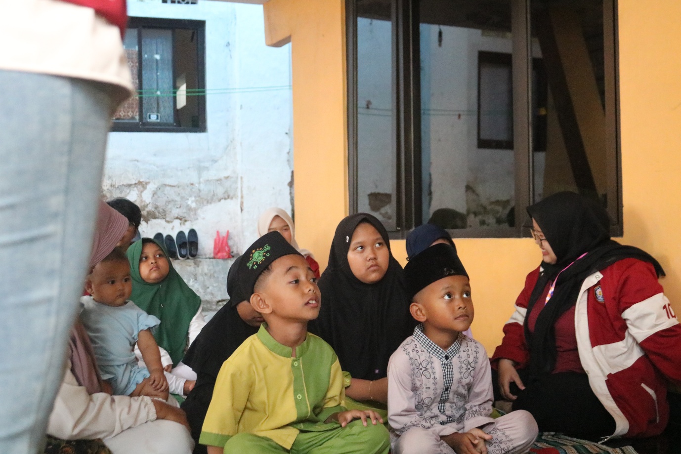A group of children sitting on a floor AI-generated content may be incorrect.